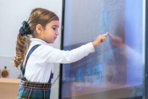 Alumna de Primaria aprendiendo con pantalla interactiva en el aula del Highlands School Barcelona